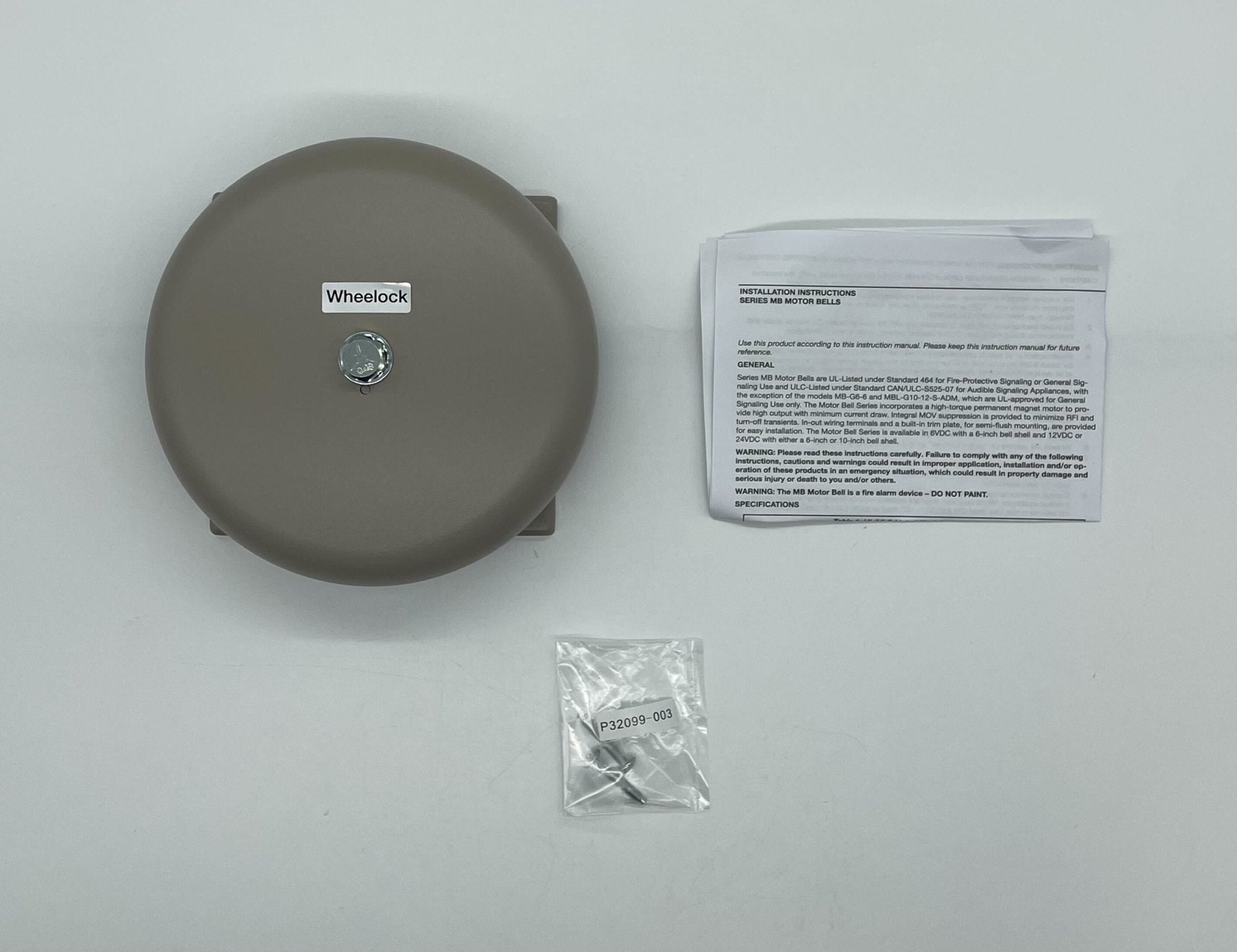 Eaton Wheelock MB-G6-24-S bell with metal casing and mounting bracket, designed for industrial alarm and signaling systems