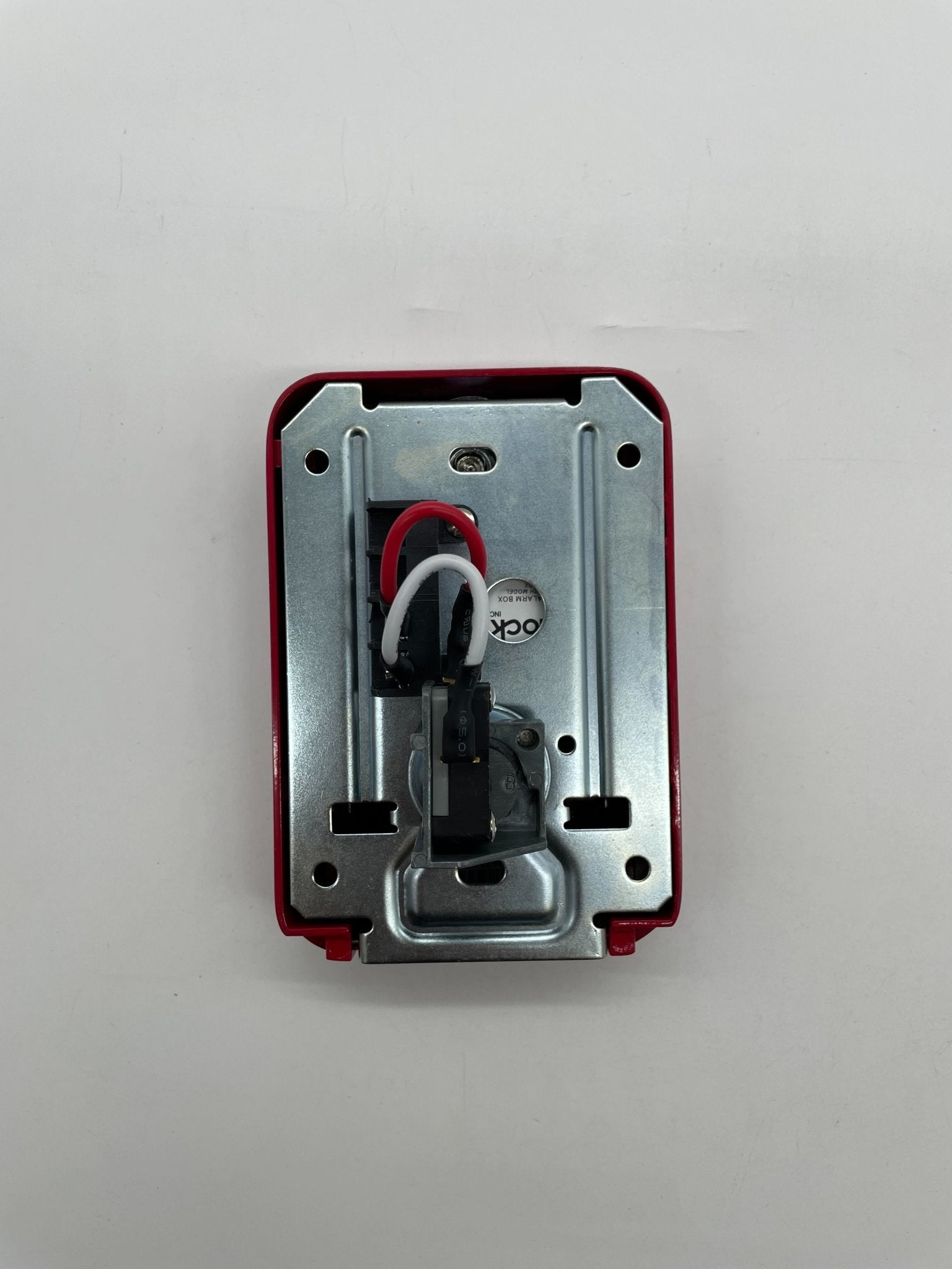 Eaton Wheelock MPS-100 pull station alarm switch with red cover and metal frame for emergency notification.