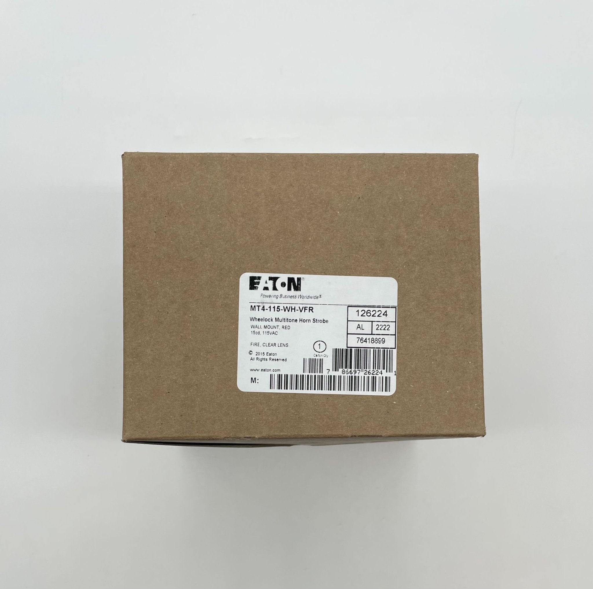 Eaton Wheelock MT4-115-WH-VFR strobe light mounted on ceiling, white housing, used for warning and signaling in commercial spaces