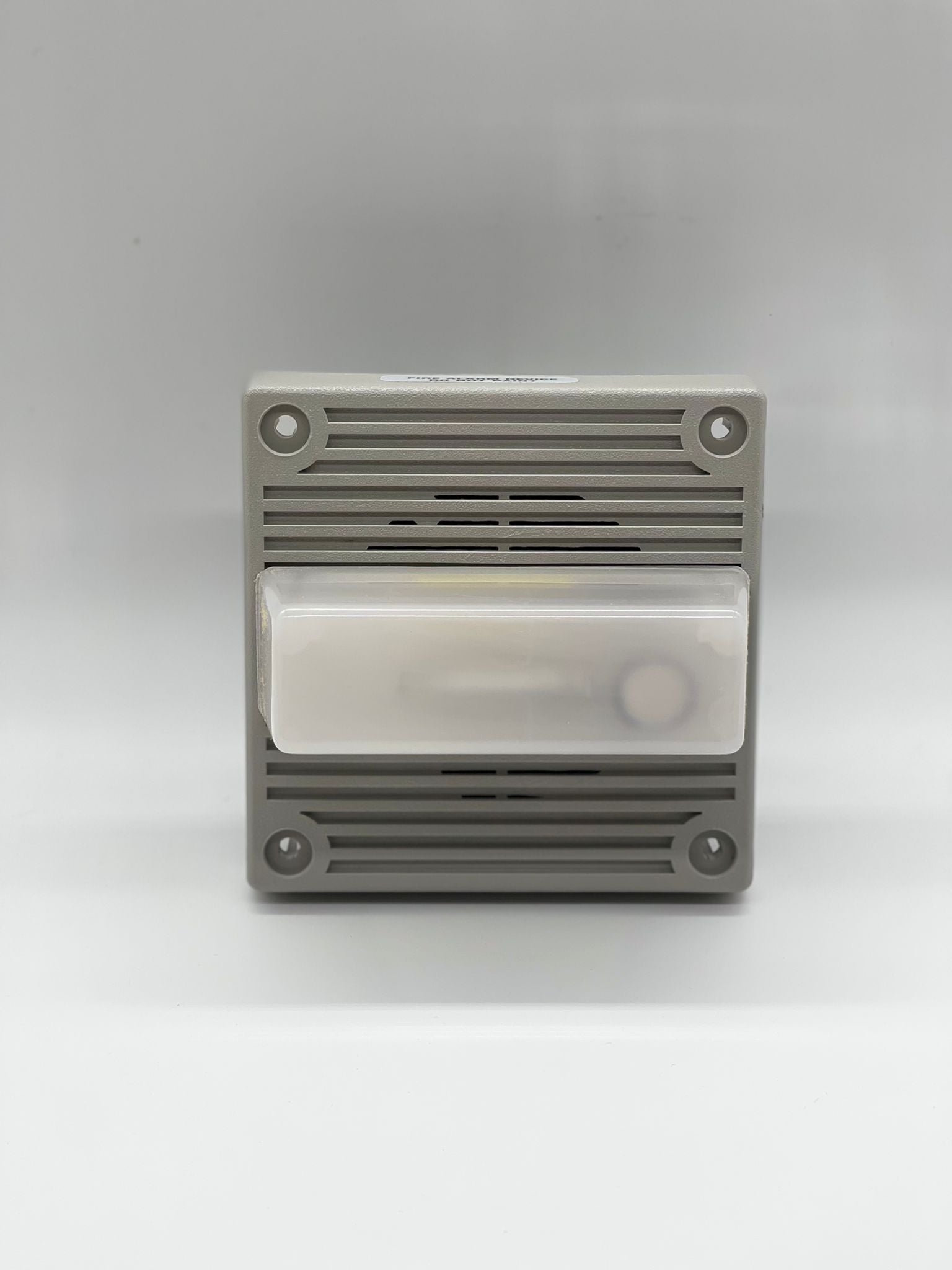 Eaton Wheelock MT4-115-WH-VFR strobe light mounted on a ceiling for emergency signaling, white housing with clear lens.
