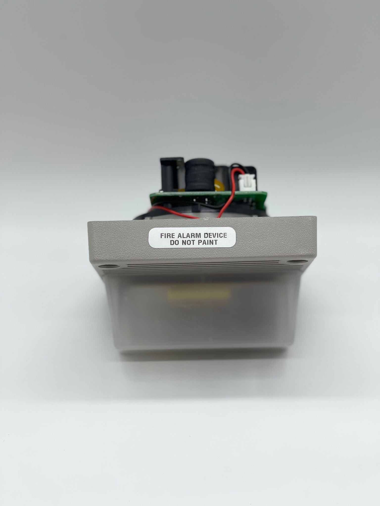 Eaton Wheelock MT4-115-WH-VFR strobe light with white housing, mounted on a ceiling for emergency signaling.