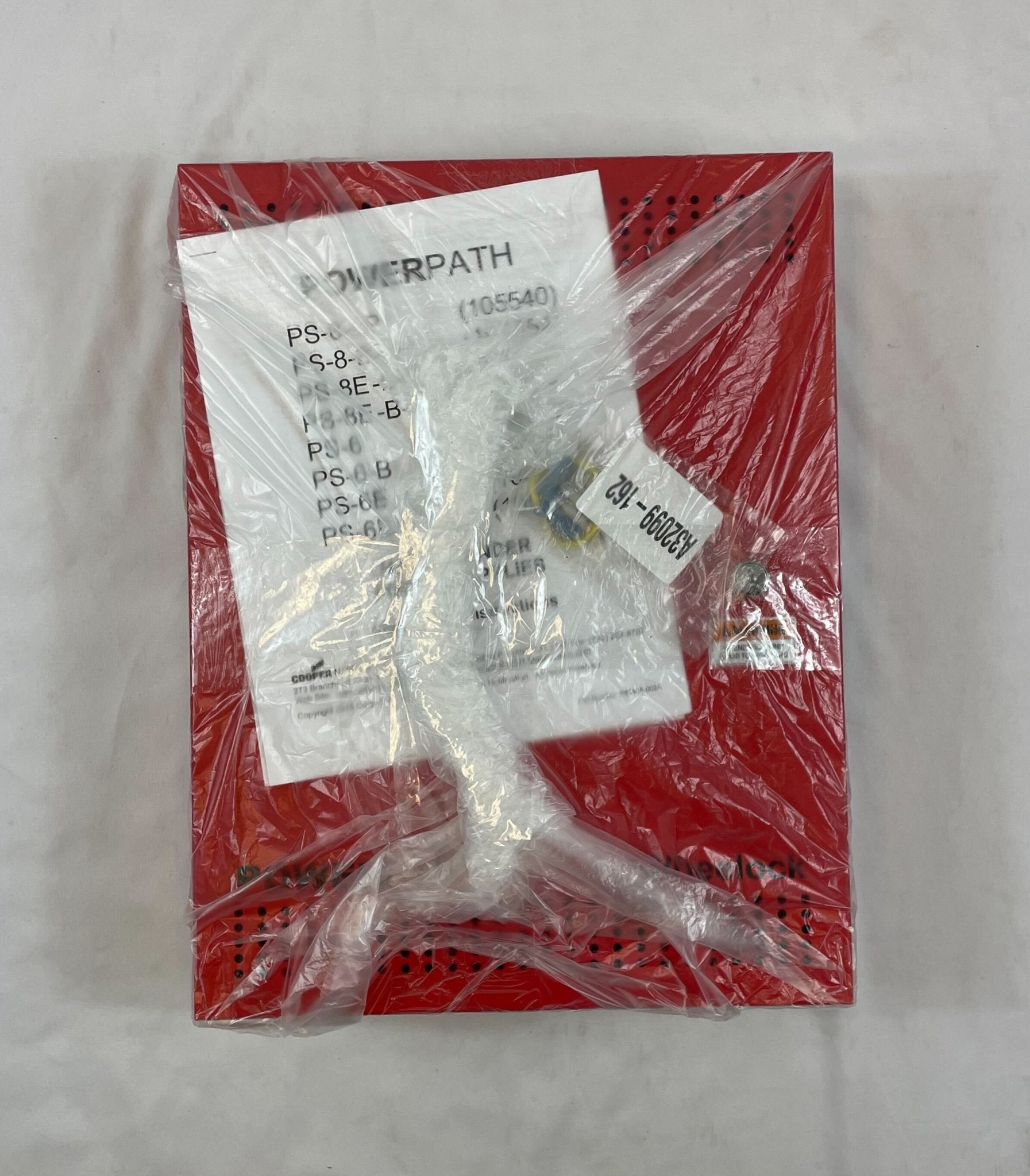 Eaton Wheelock PS-8-LP power supply unit with multiple connection ports, mounted on a white surface.