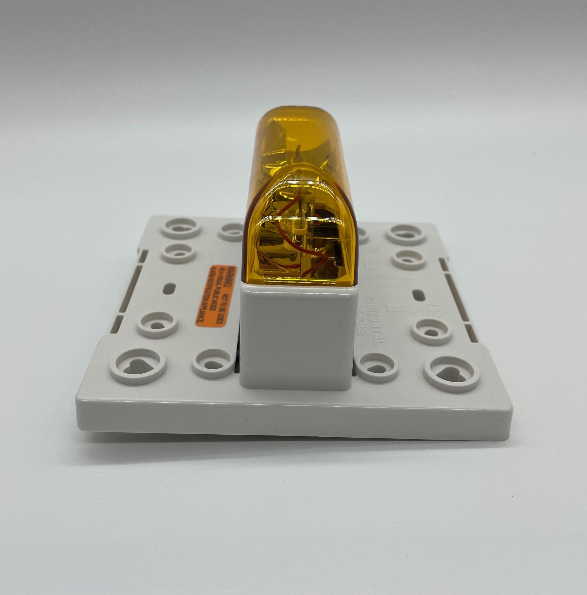 Eaton Wheelock RSSA-24MCC-NW strobe light with black housing, mounted on a ceiling for emergency signaling.