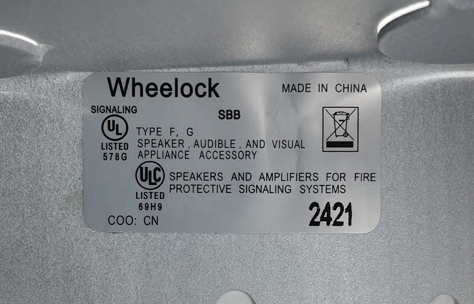 Eaton Wheelock SBB-W backbox mounted on wall, metal electrical enclosure with knockout openings for wiring.