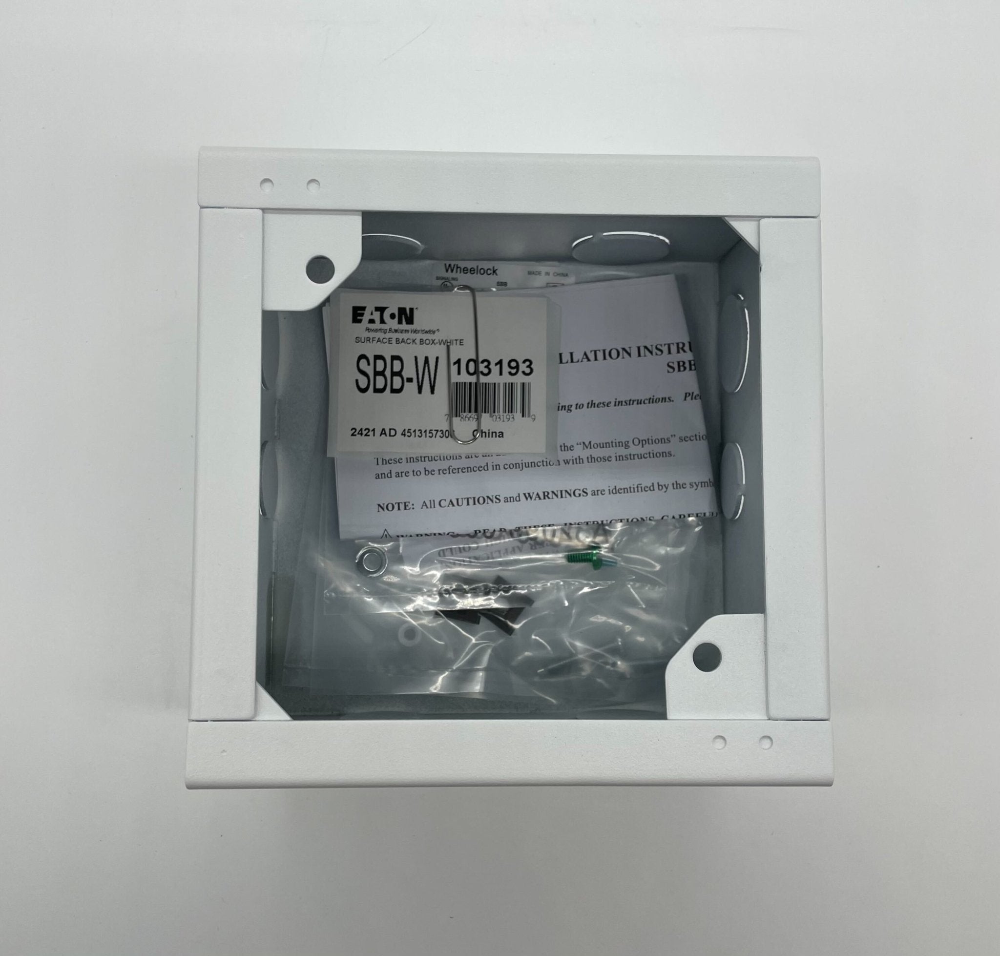 Eaton Wheelock SBB-W backbox for electrical installations, shown in a close-up view with mounting features visible.