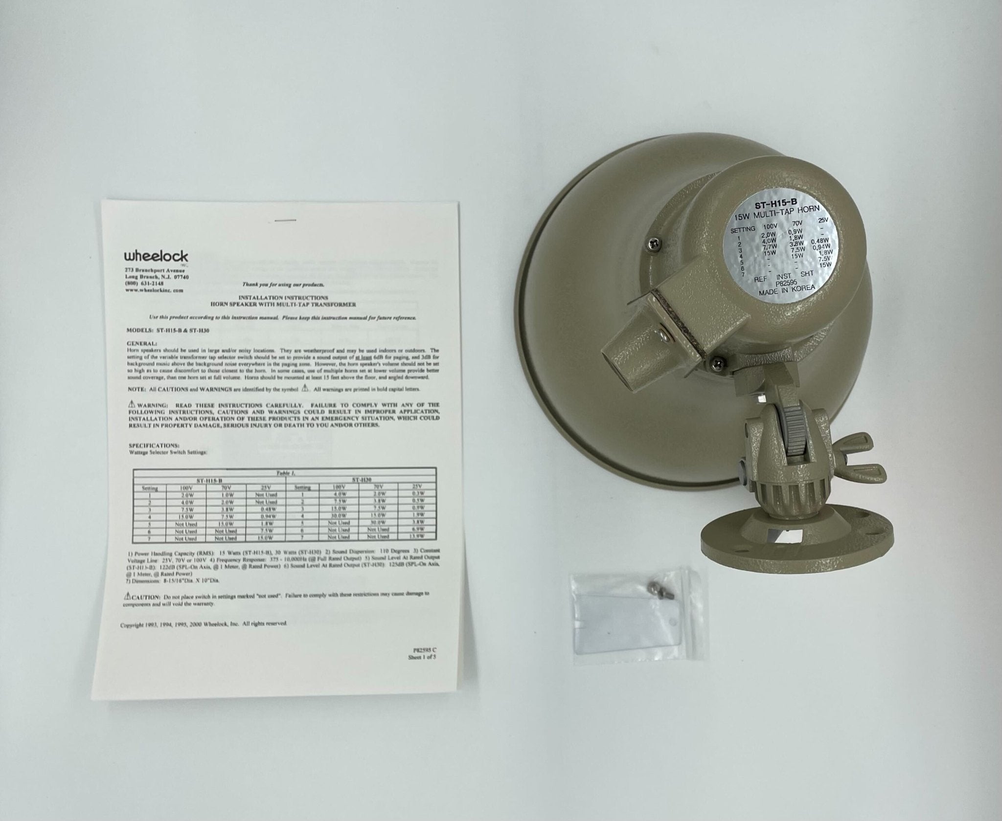 Eaton Wheelock ST-H15-B fire alarm horn strobe with red housing and mounting bracket, designed for fire safety systems.