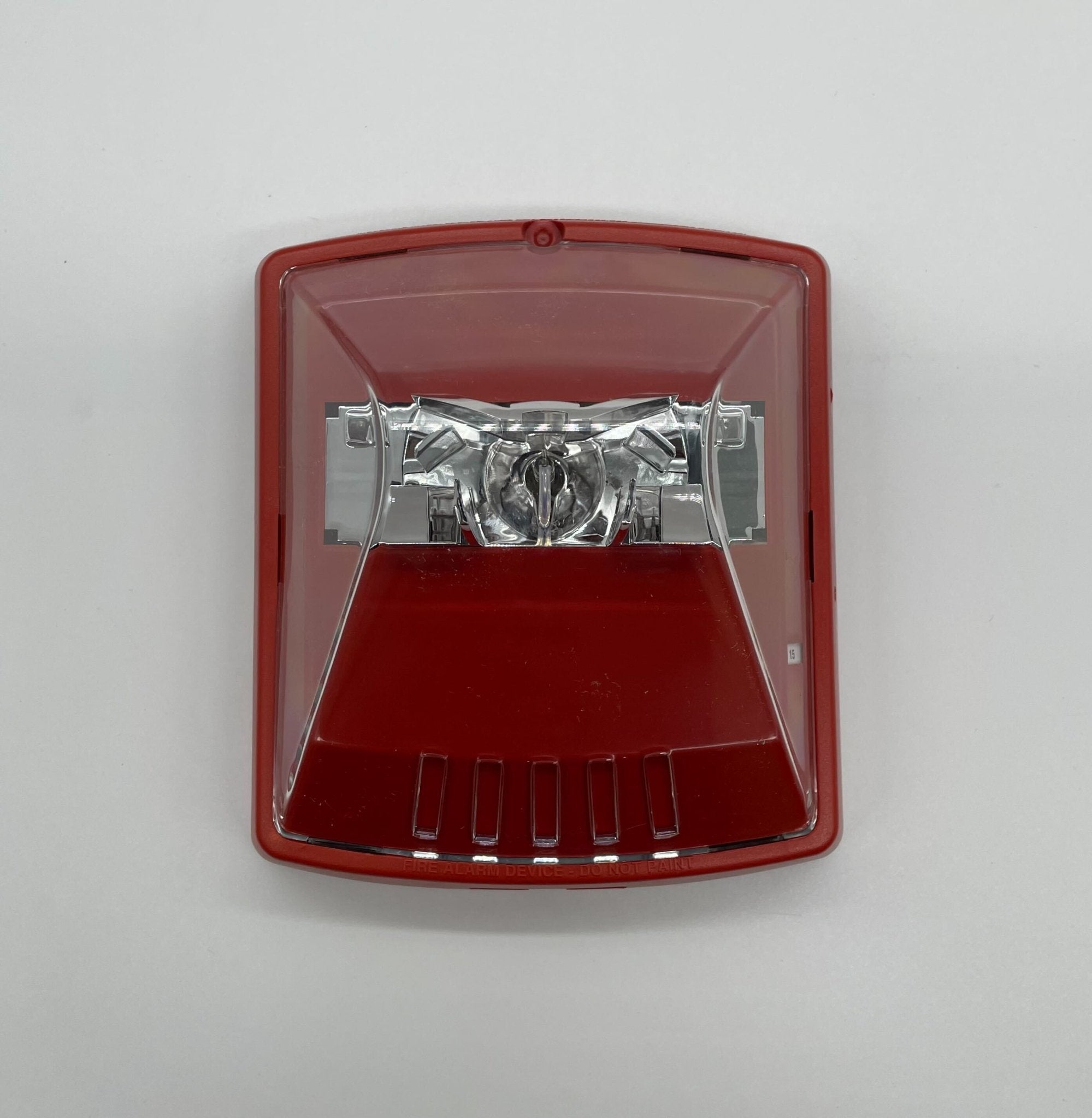Eaton Wheelock STR-N strobe light with clear lens and mounting bracket, designed for emergency signaling and safety alert systems