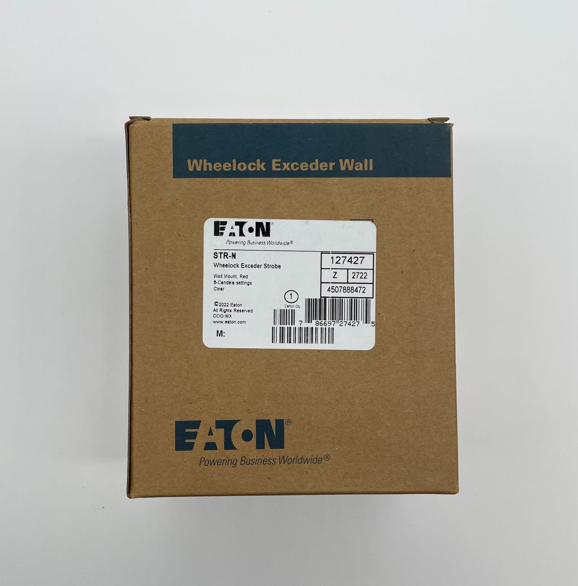 Eaton Wheelock STR-N strobe light with clear lens and mounting hardware, designed for emergency warning systems.