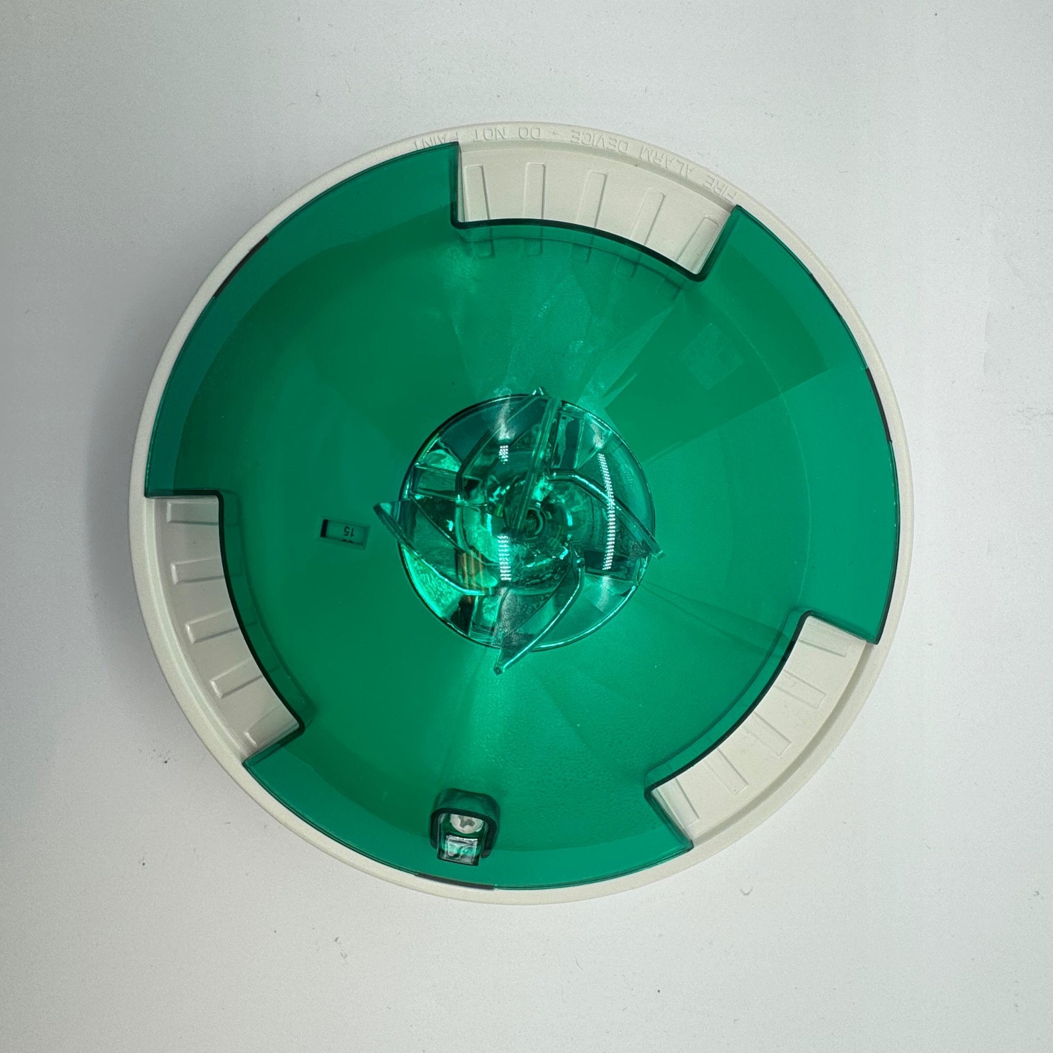Eaton Wheelock STWC-NG fire alarm with yellow alarm horn and black mounting base on a white background