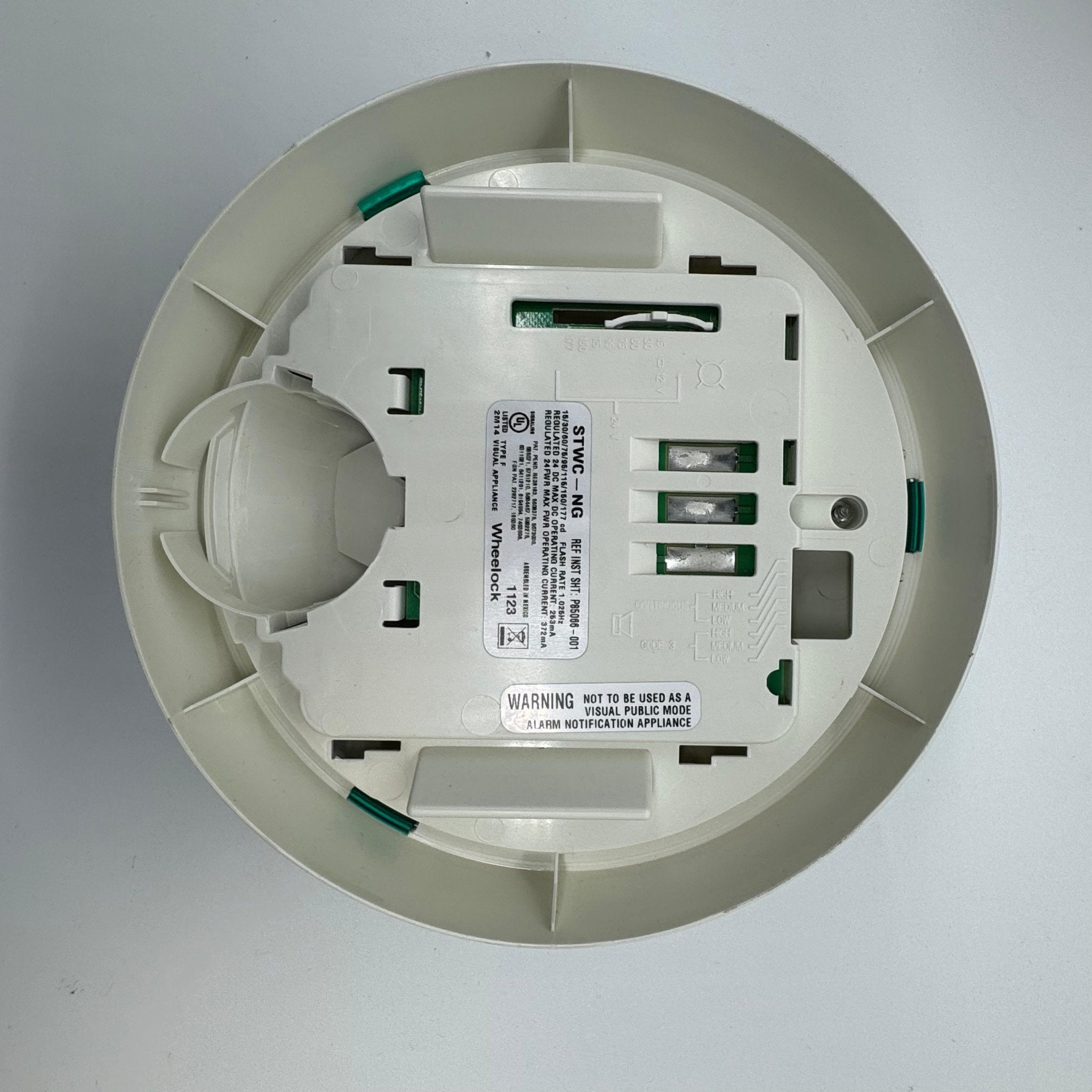 Eaton Wheelock STWC-NG fire alarm with smoke detector and control module, mounted on wall in a building safety system.