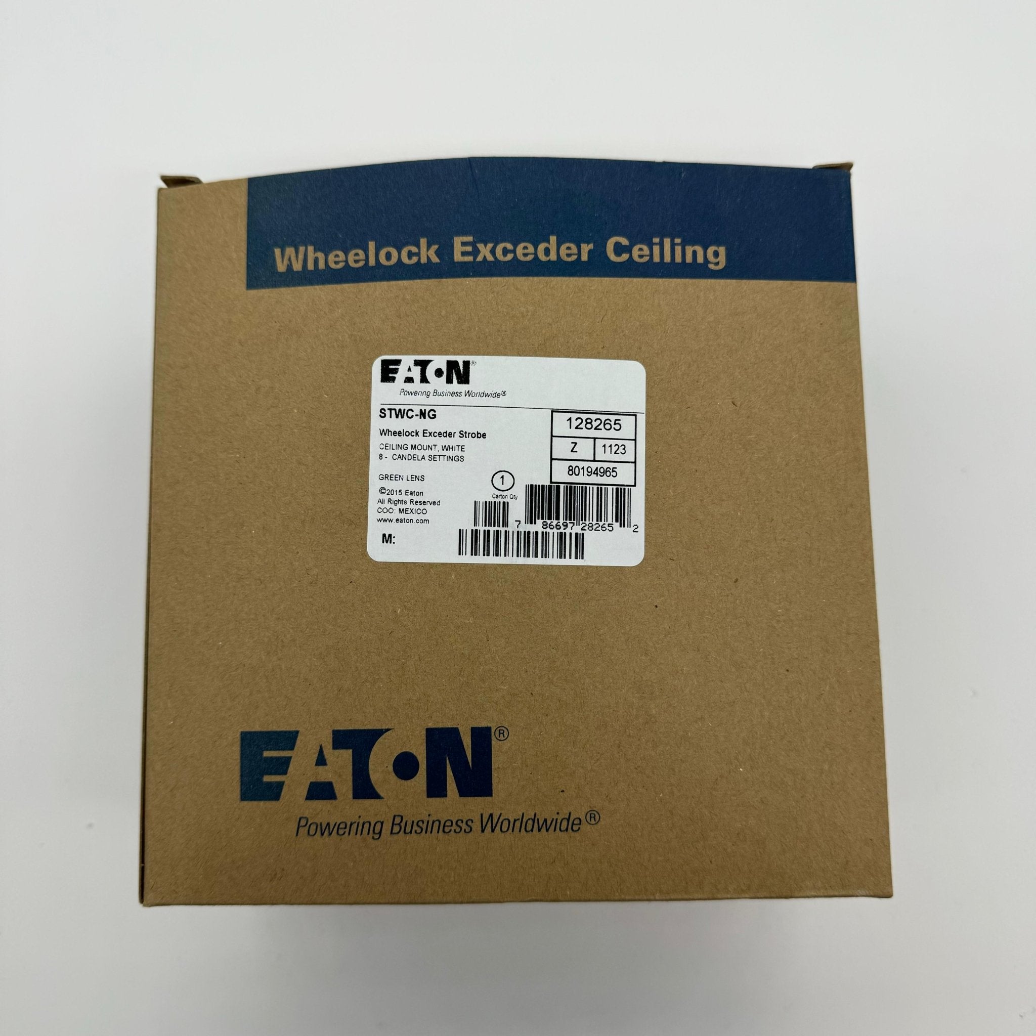 Eaton Wheelock STWC-NG fire alarm with mounting base, white plastic housing, and wiring terminals for emergency notification.