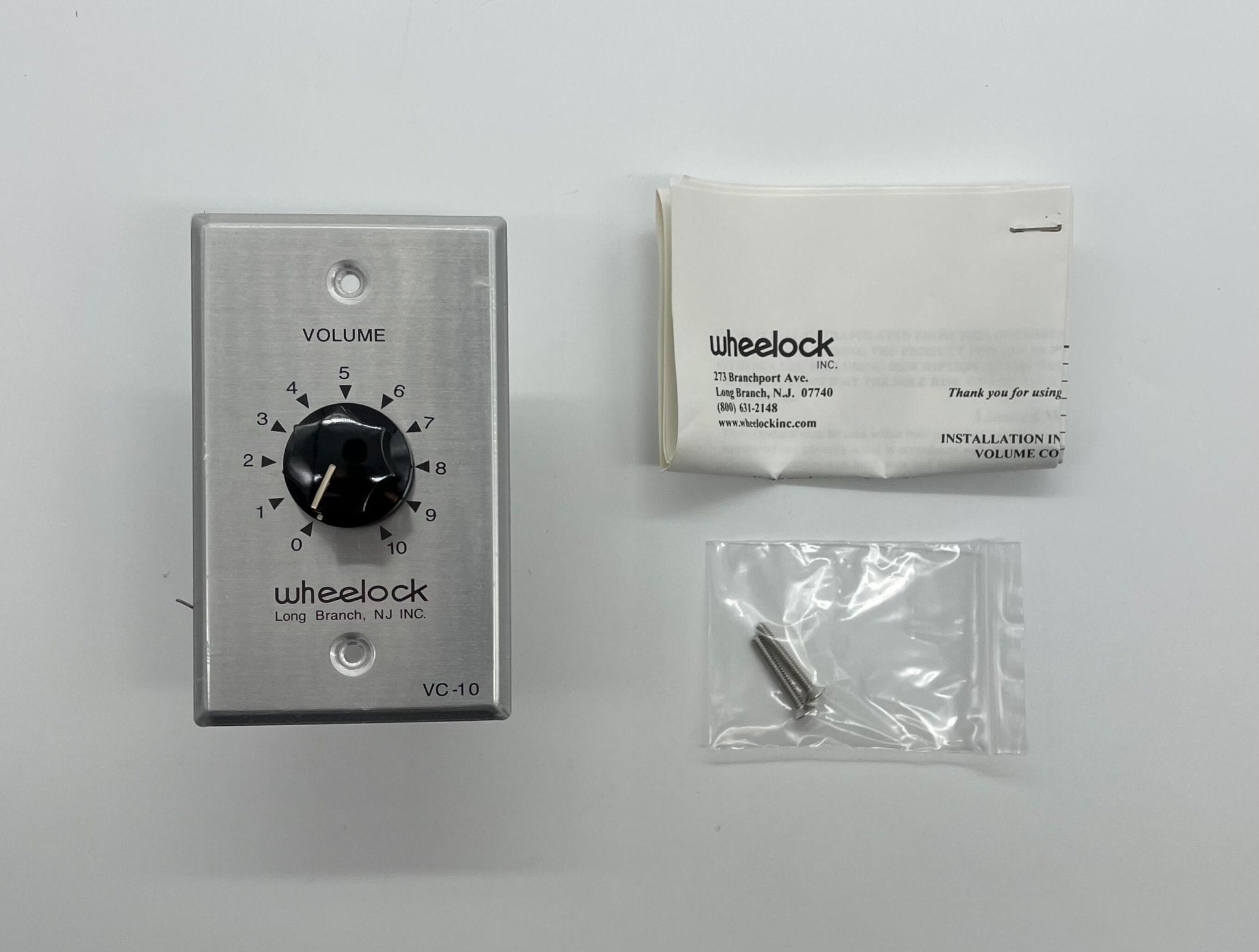 Eaton Wheelock VC-10 fire alarm horn/strobe with red housing and mounting bracket for emergency alert systems.
