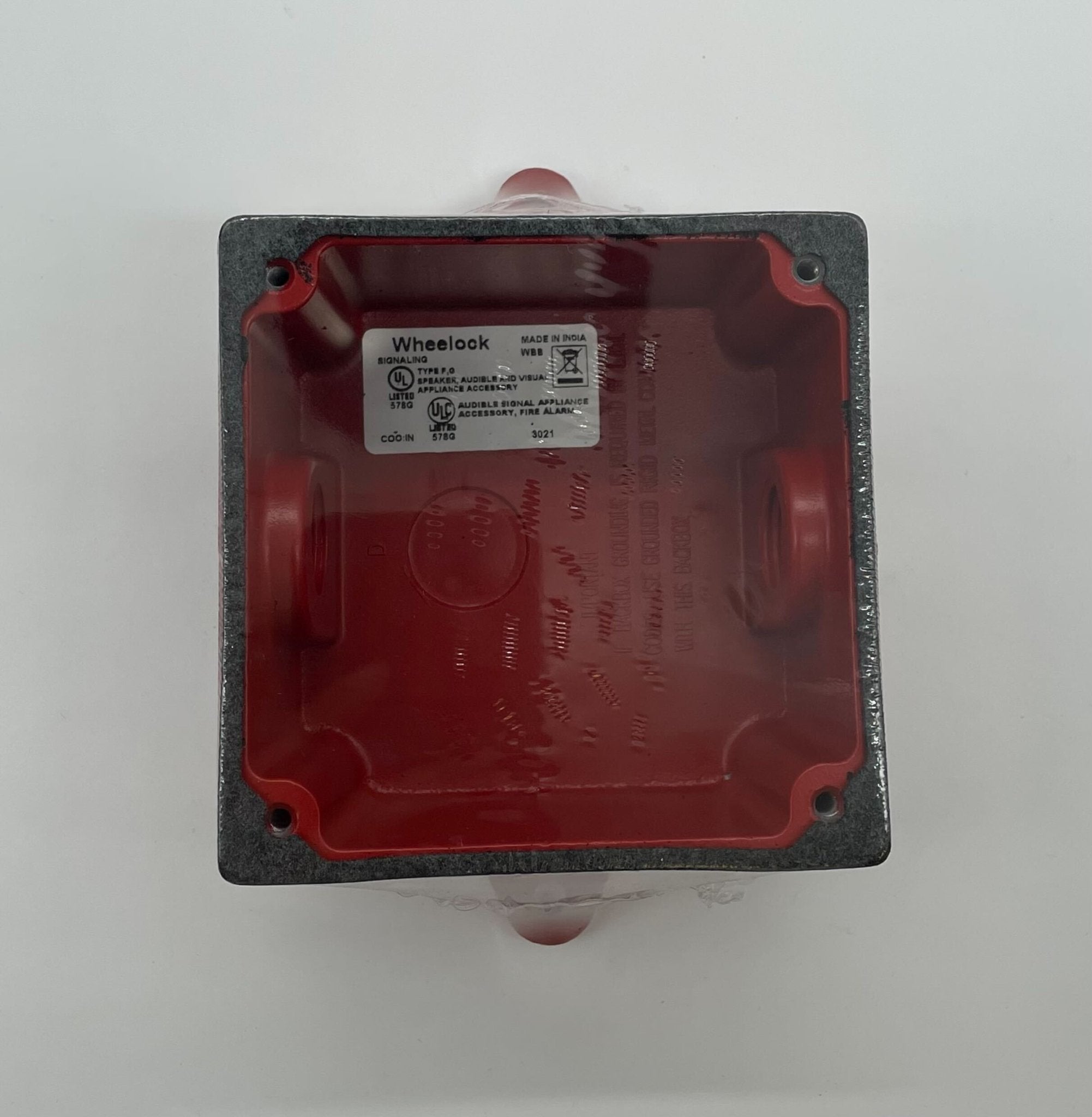 Eaton Wheelock WBB-R-1/2T-1/2B backbox showing metal enclosure with mounting holes for electrical wiring and device installation.