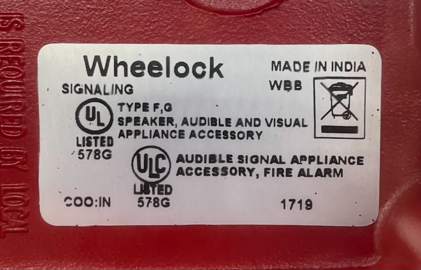 Eaton Wheelock WBB-R-3/4T-3/4B backbox mounted on a wall, showing durable metal construction and standard size for electrical installations.