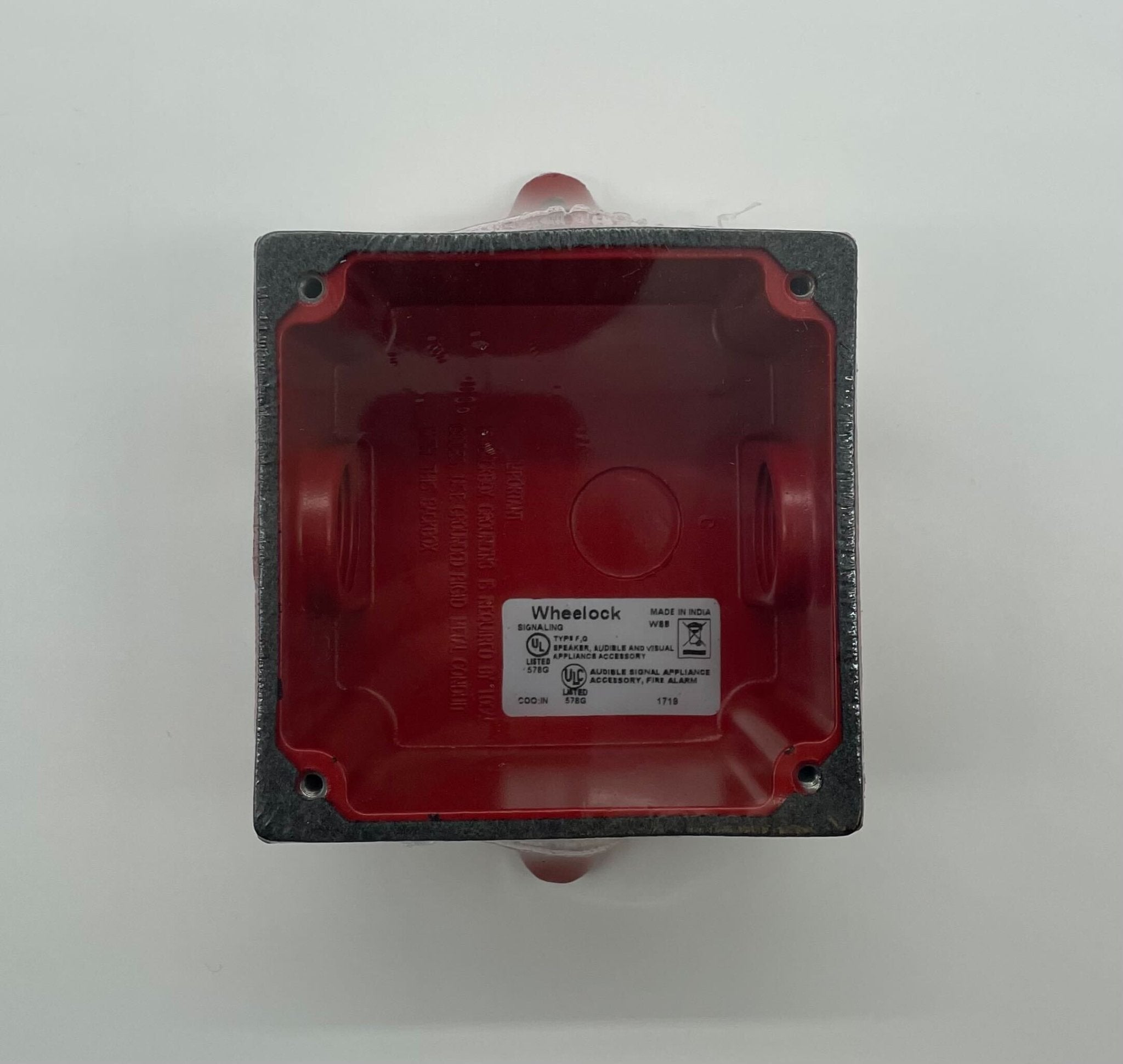 Eaton Wheelock WBB-R-3/4T-3/4B backbox, metal enclosure with knockout openings for electrical wiring, mounted on a wall.