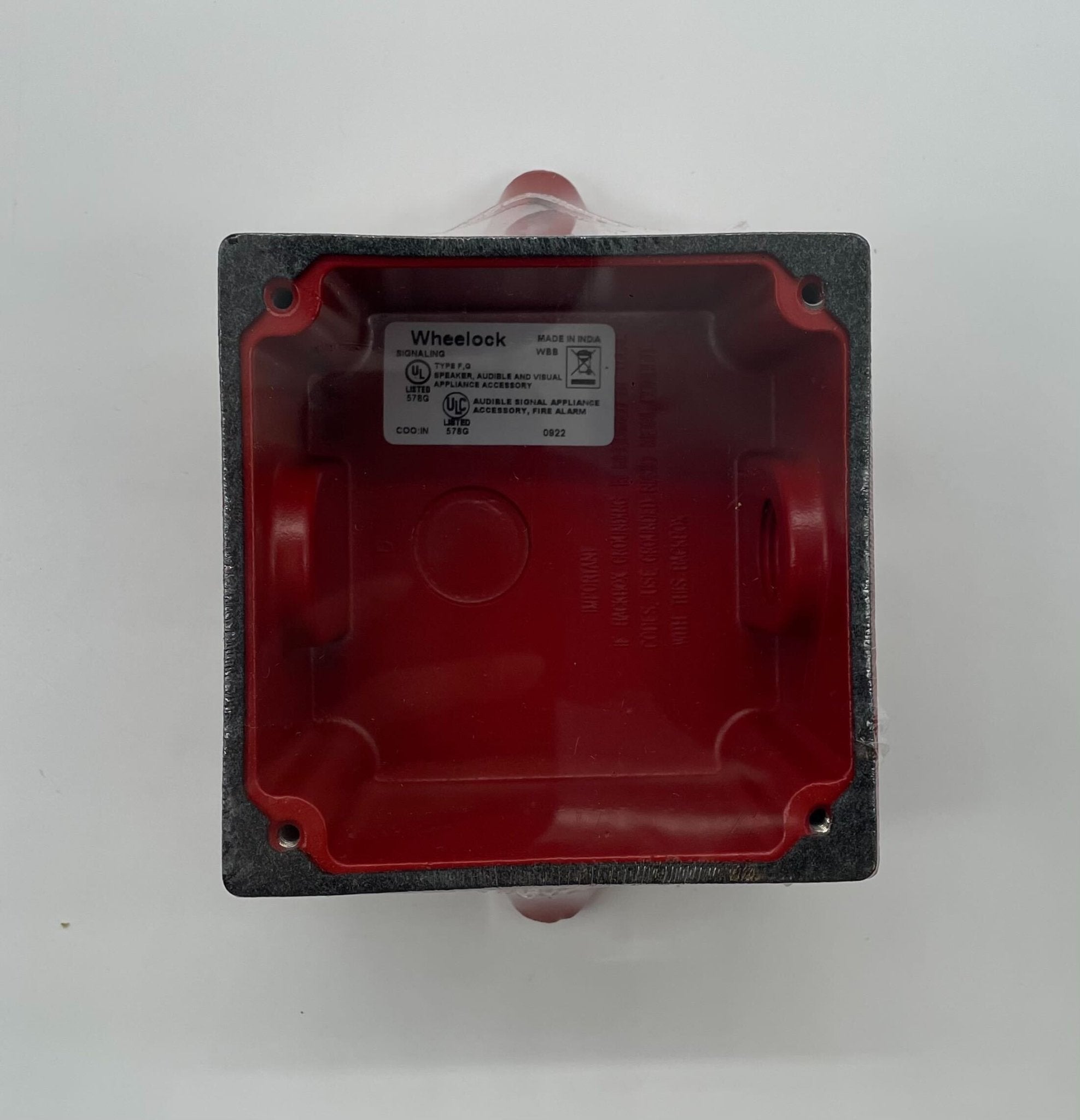 Eaton Wheelock WBB-R backbox mounted on a wall, used for electrical wiring and device installation, with a metal construction.