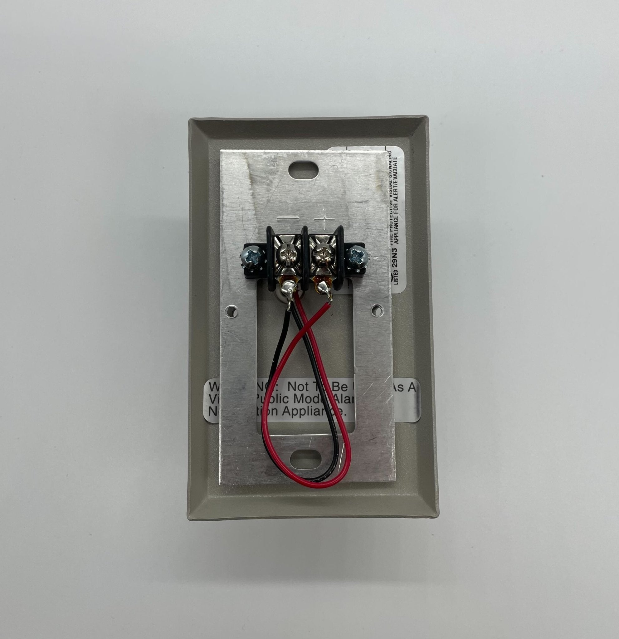 Eaton Wheelock WH1T-115-NS strobe light with white housing, mounted on a ceiling for emergency signaling.