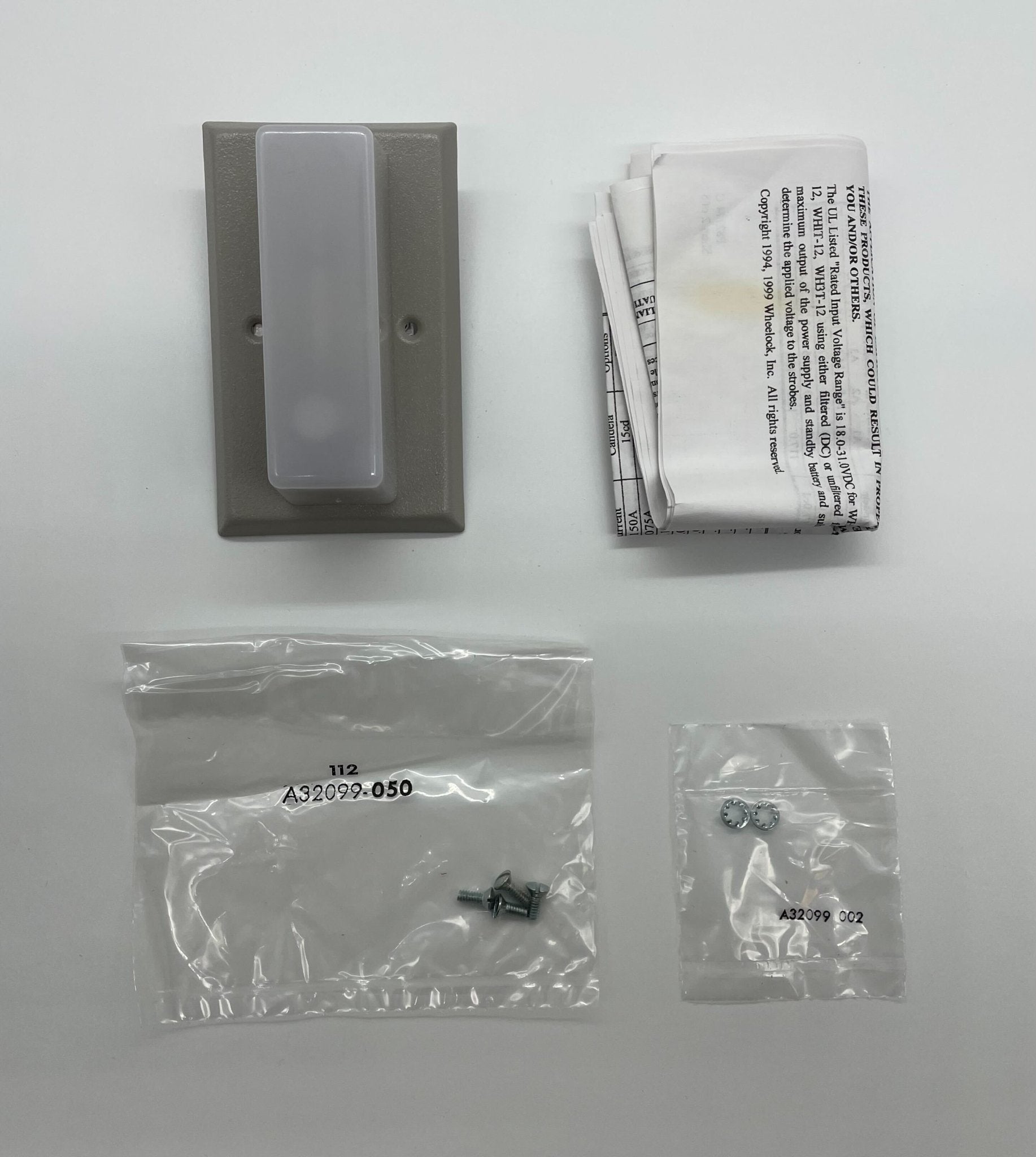 Eaton Wheelock WH1T-115-NS strobe light with clear lens and mounting hardware, designed for visual warning alerts.