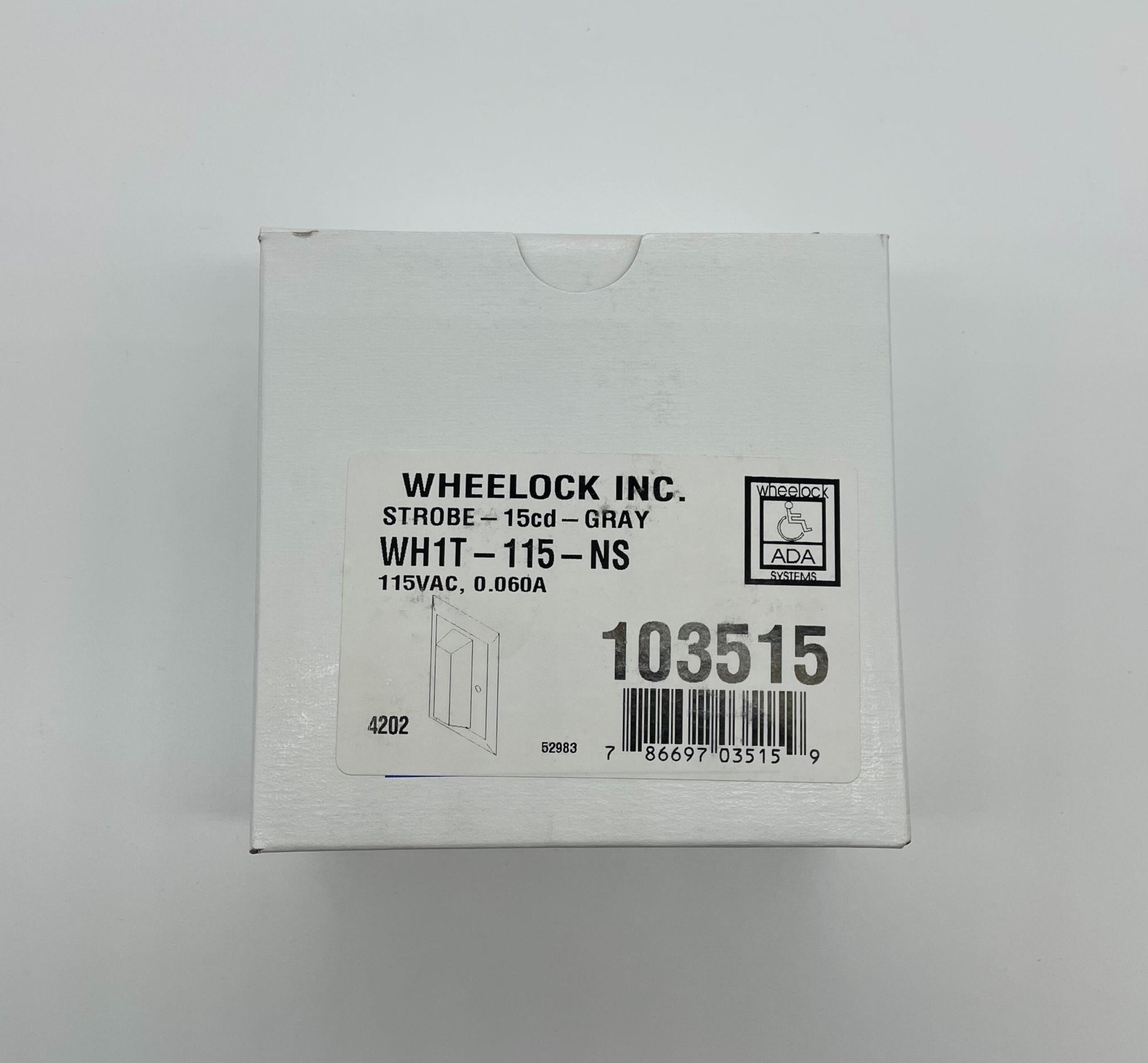 Eaton Wheelock WH1T-115-NS strobe light with white housing and clear lens, mounted on a wall for emergency signaling.
