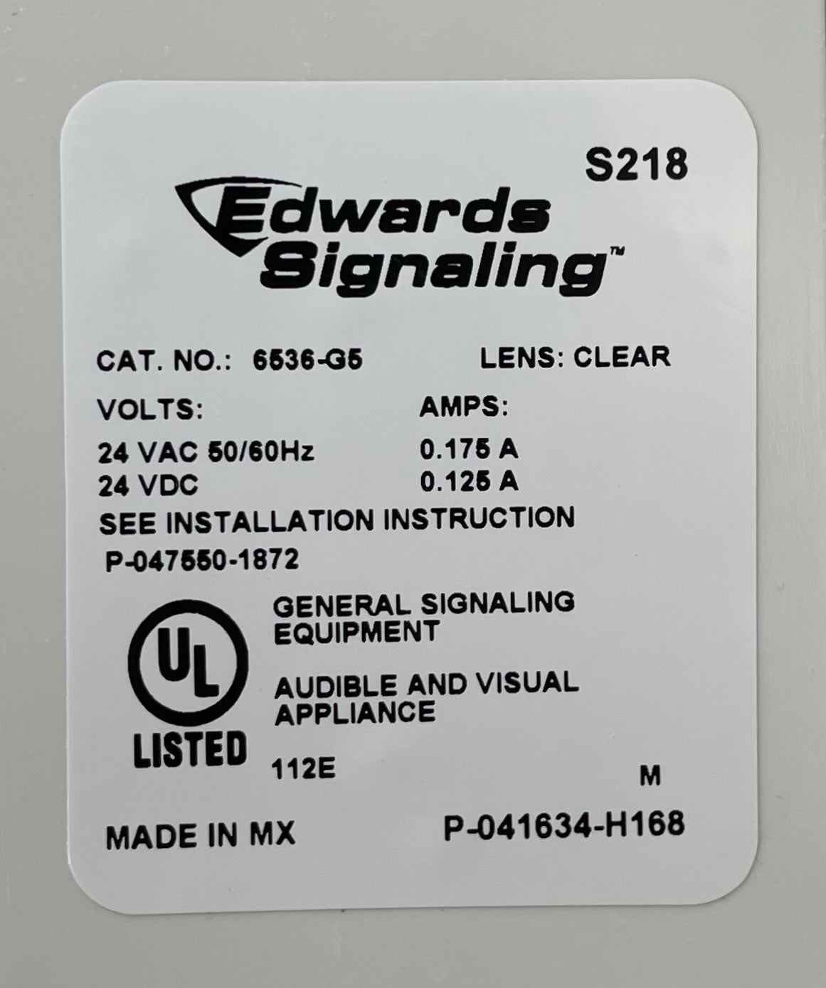Edwards 7005-G5 fire alarm device mounted on wall, featuring test and reset buttons, designed for building safety.