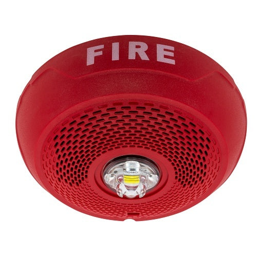 System Sensor SPSCRLED emergency exit sign with LED illumination, mounted on a wall for clear visibility and safety indication.