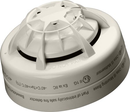 Apollo fire alarm sensor with ULC marking, mounted on ceiling, featuring a round design and detection components.