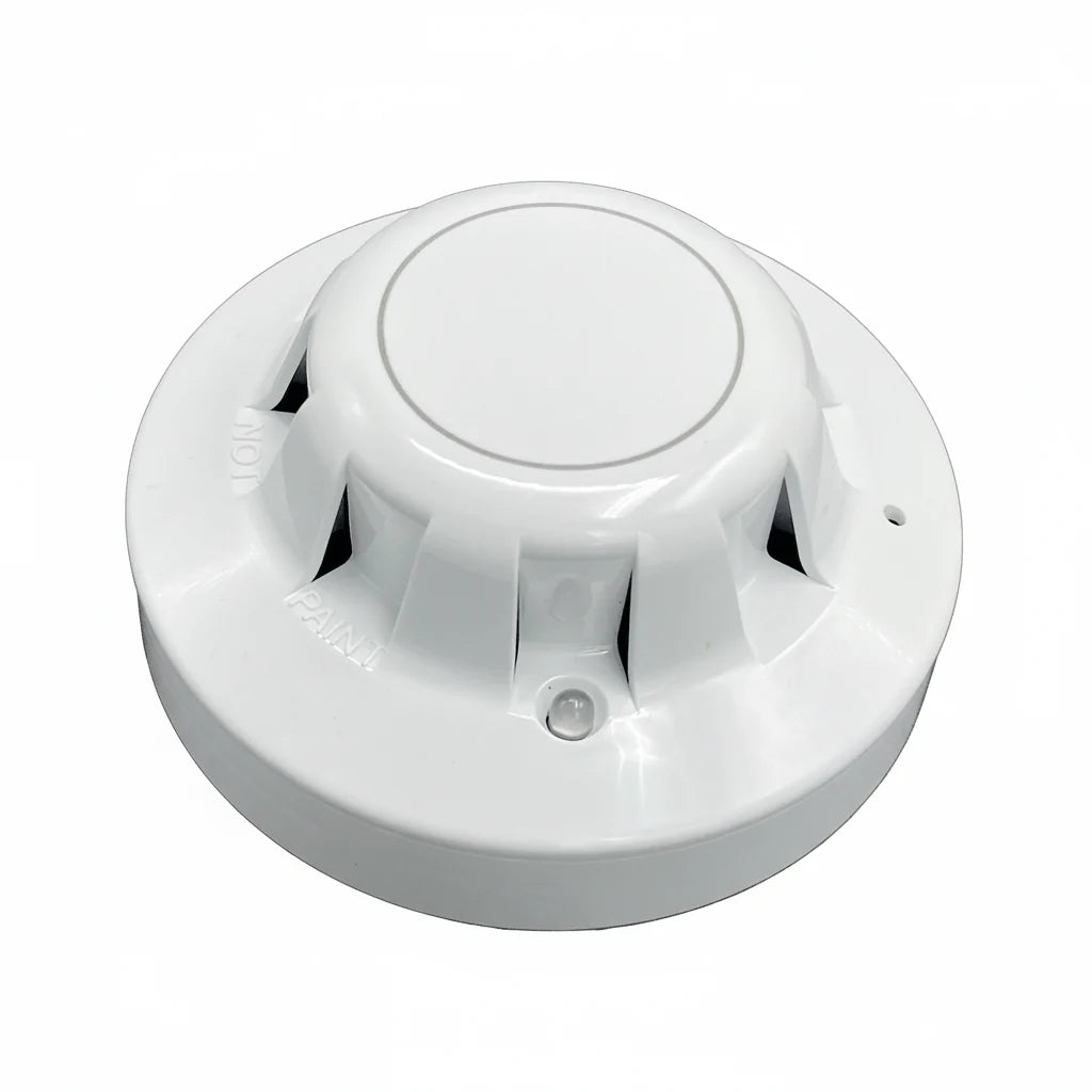 APC 55000-335DCT fire alarm by Air Products and Controls, mounted on wall, with visible alarm sensor and wiring.