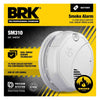 BRK SM310 battery-operated smoke alarm mounted on ceiling, with test button and sensor area visible.