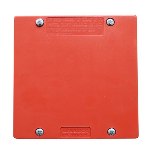 Eaton Wheelock DSM-12/24-R sync module showing a compact black device with connection ports for fire alarm systems