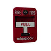 Eaton Wheelock MPS-100 pull station mounted on wall, black metal housing and red pull handle for emergency alarm activation.