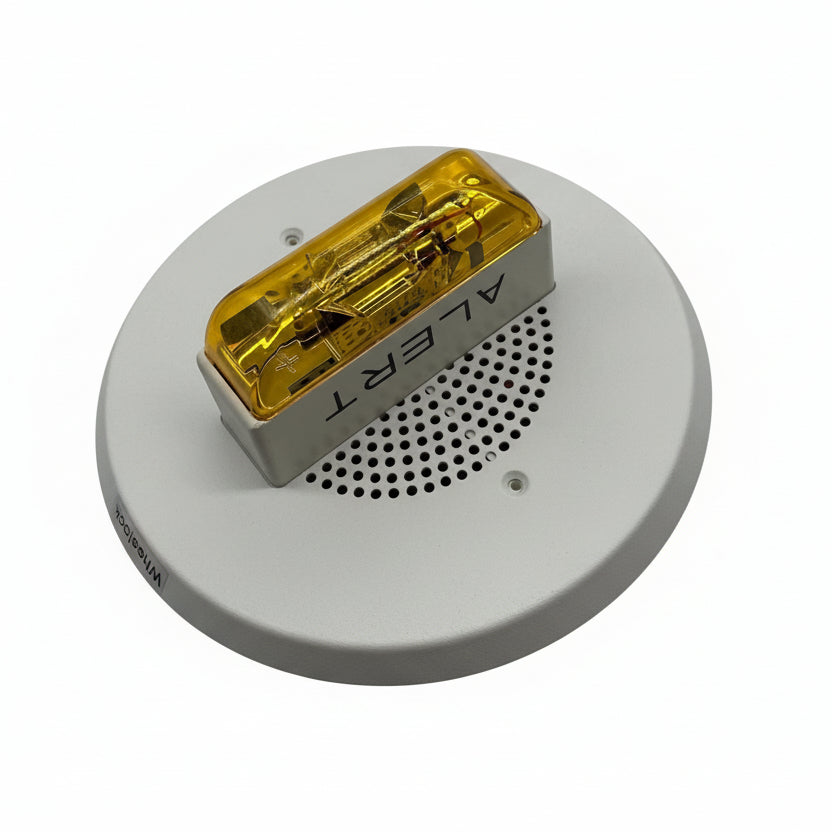 Eaton Wheelock E90A-24MCC-ALW speaker strobe alarm device mounted on wall, with clear visibility of the product model and brand.