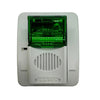 Gentex GECG24PWW fire alarm horn strobe with green lens, mounted on wall, for emergency warning and safety signaling.