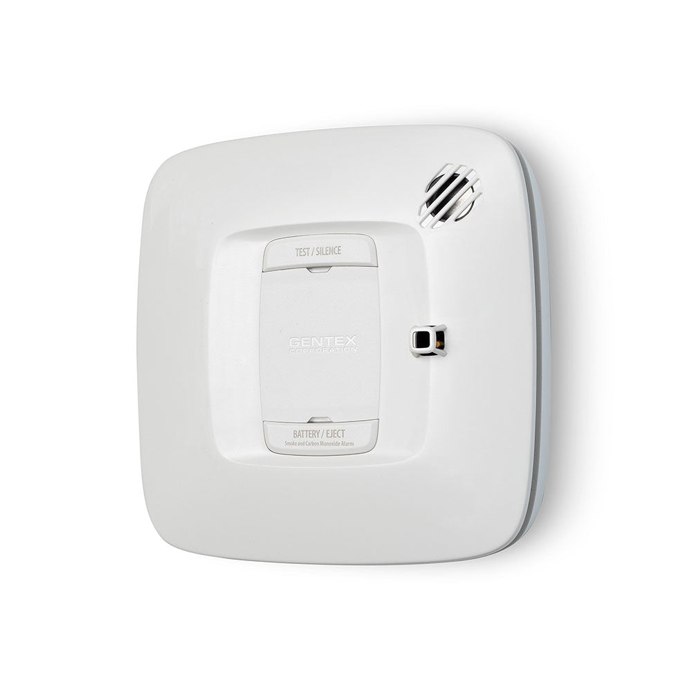 Gentex SCR smoke and carbon monoxide alarm detector with relay, 120VAC, mounted on wall, showing digital display and sensor.
