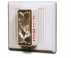 Edwards 2452THS-110-W fire alarm with digital display and sensor, mounted on a white wall in a commercial building.