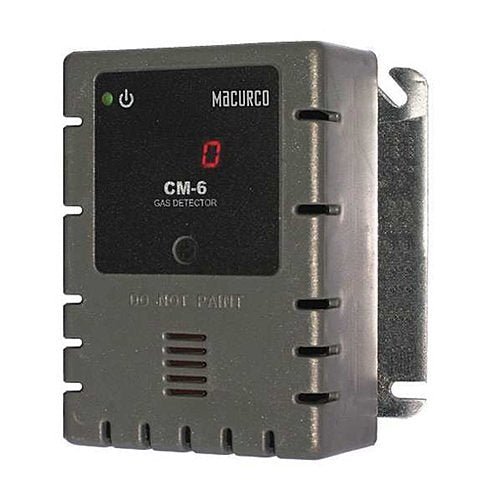 Macurco CM-6 carbon monoxide detector mounted on wall, featuring digital display and compact design for safety monitoring.