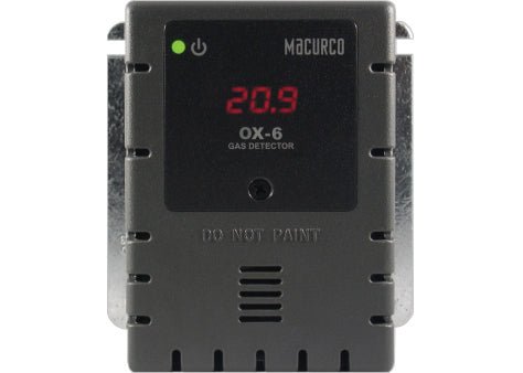 Macurco OX-6 gas detector installed in a commercial setting, with a compact design and digital display for monitoring gas levels.