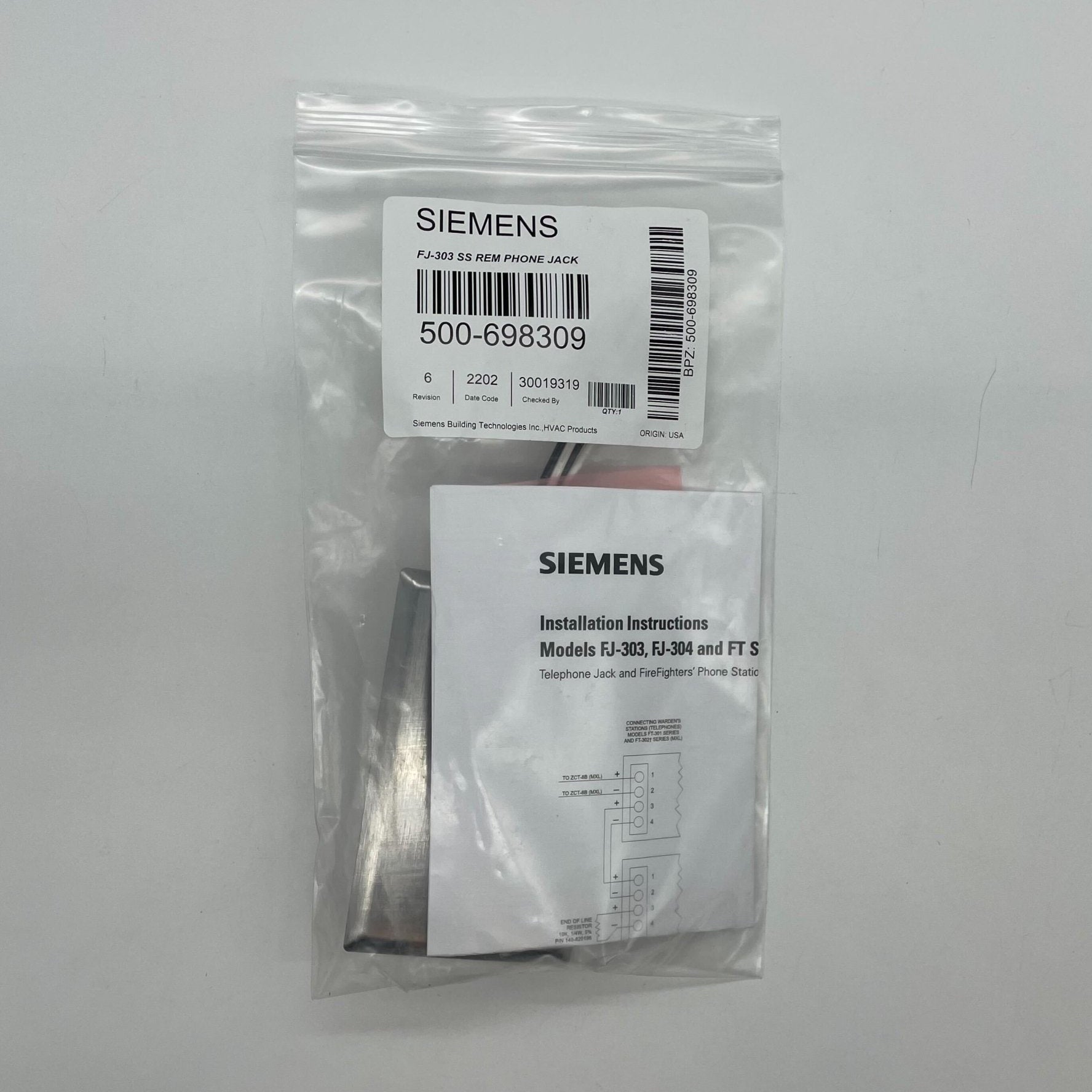 Siemens FJ-303SS fire alarm device mounted on wall, designed for fire safety and alert systems.