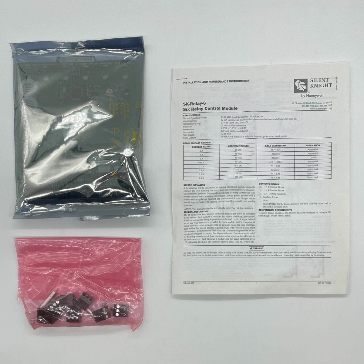 Silent Knight SK-RELAY-6 relay module with six relays, black circuit board and wiring terminals for fire alarm systems.