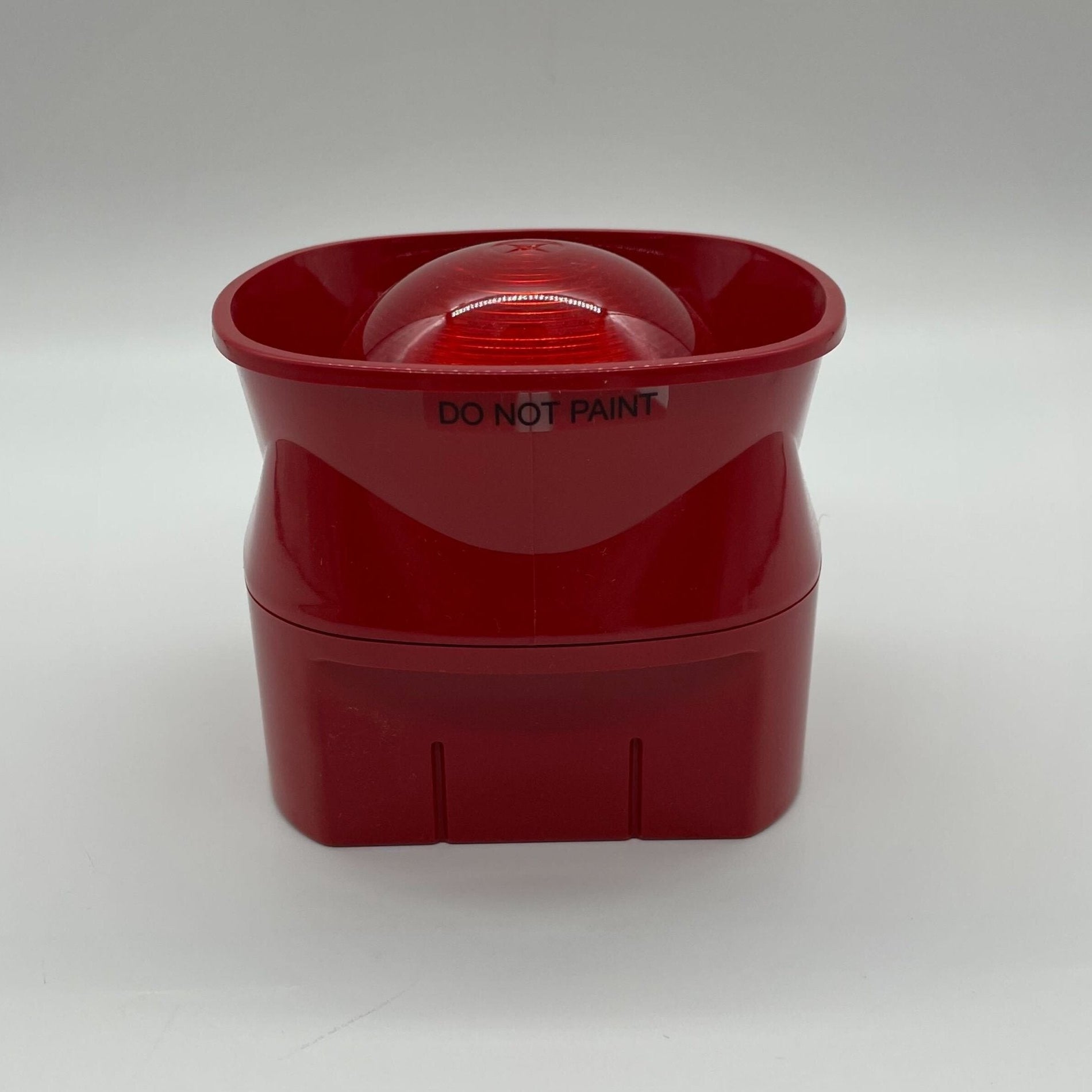 Simplex 4906-5205 beacon with red and clear lenses, mounted on a metal base, used for emergency signaling.