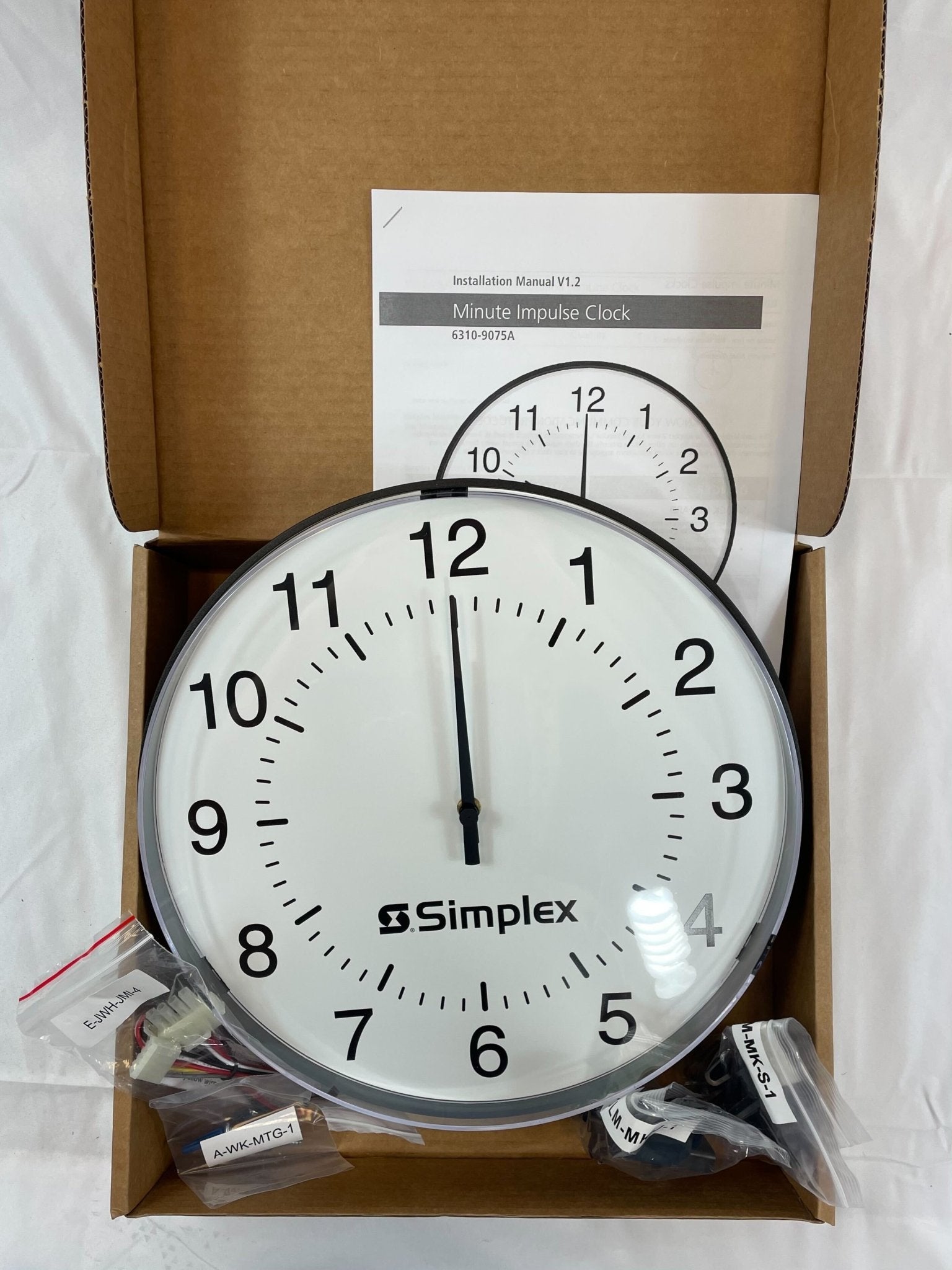Simplex 6310-9075A fire alarm device with a white plastic enclosure, designed for fire safety and alarm systems.
