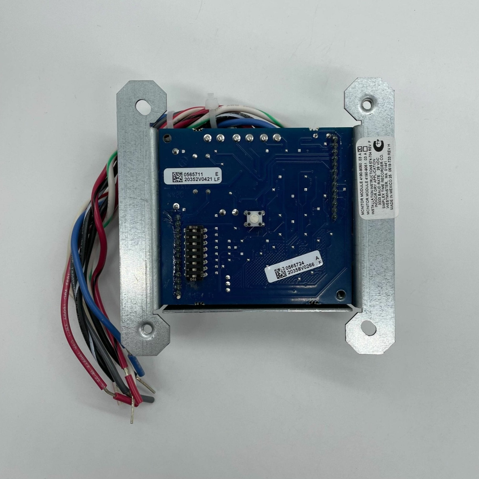 Simplex 4190-9050 fire alarm, a sleek device with a white faceplate and sensor, mounted on a wall.