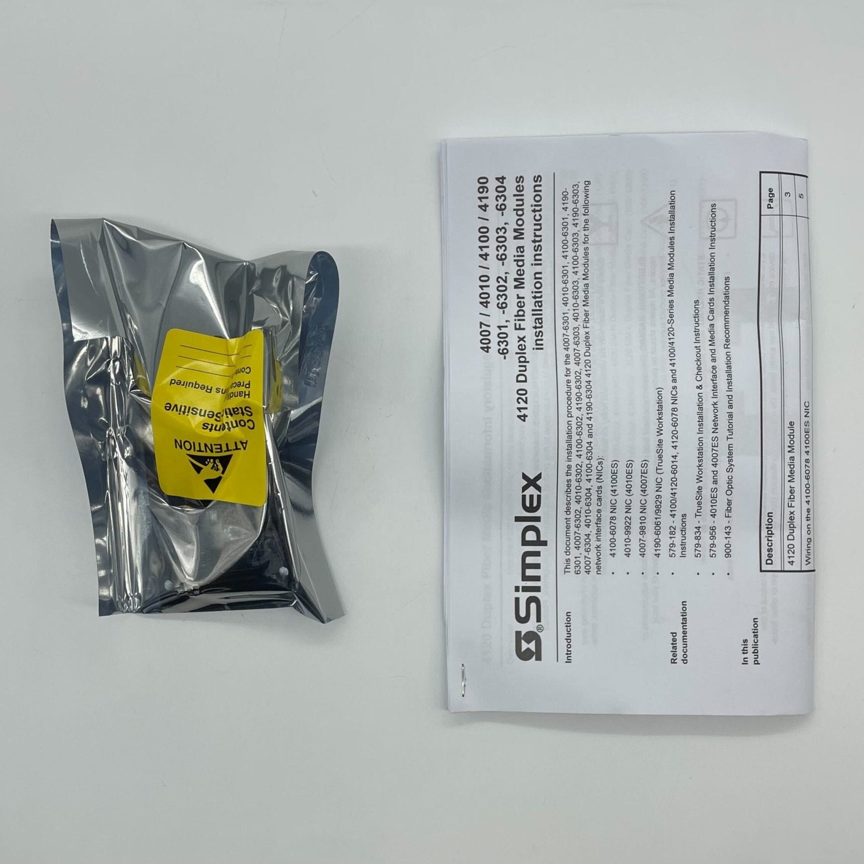 Simplex 4010-6303 fire alarm device, black with test and reset buttons, mounted on wall for fire safety detection.