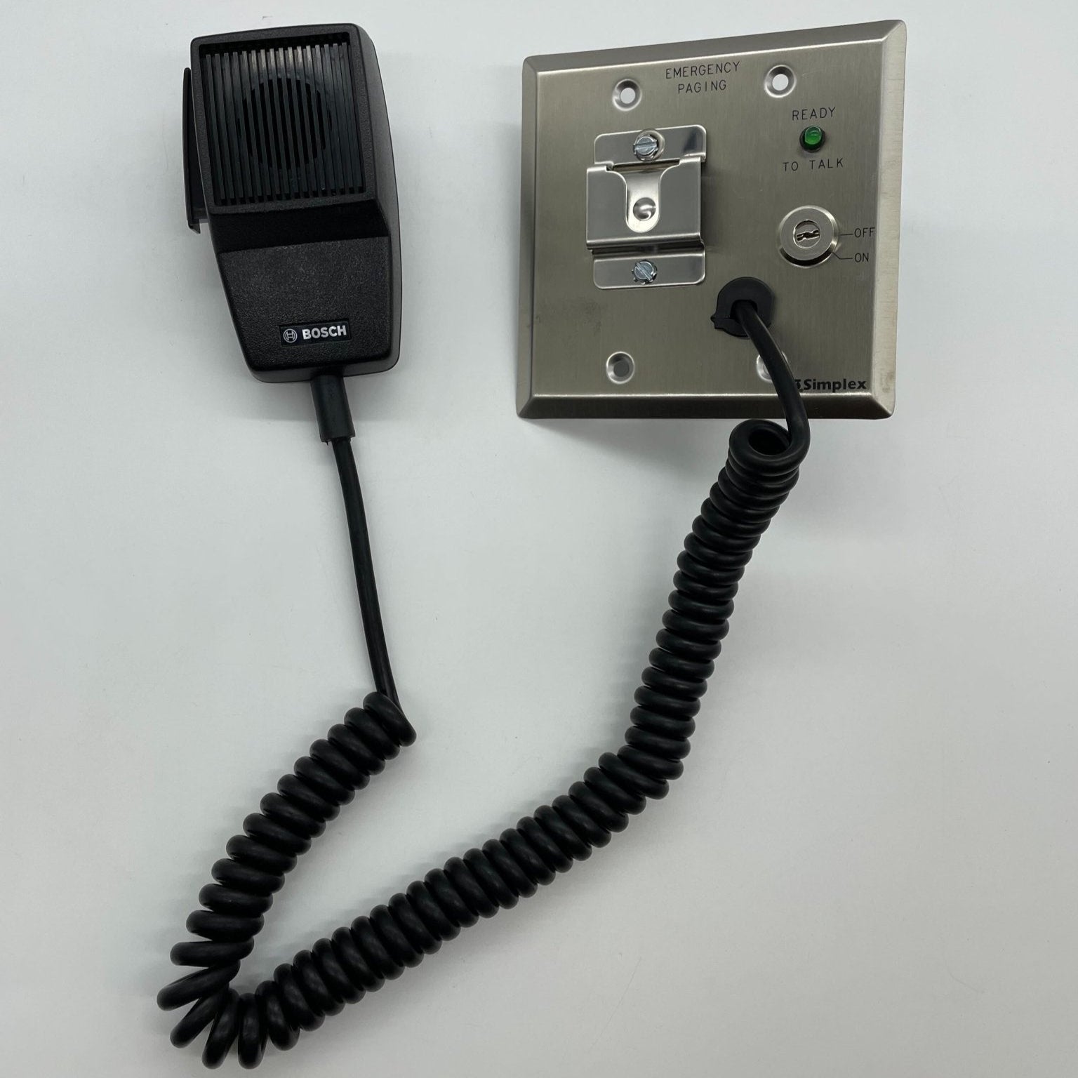 Simplex 4003-9803 fire alarm sensor showing a white circular detector with mounting hardware.