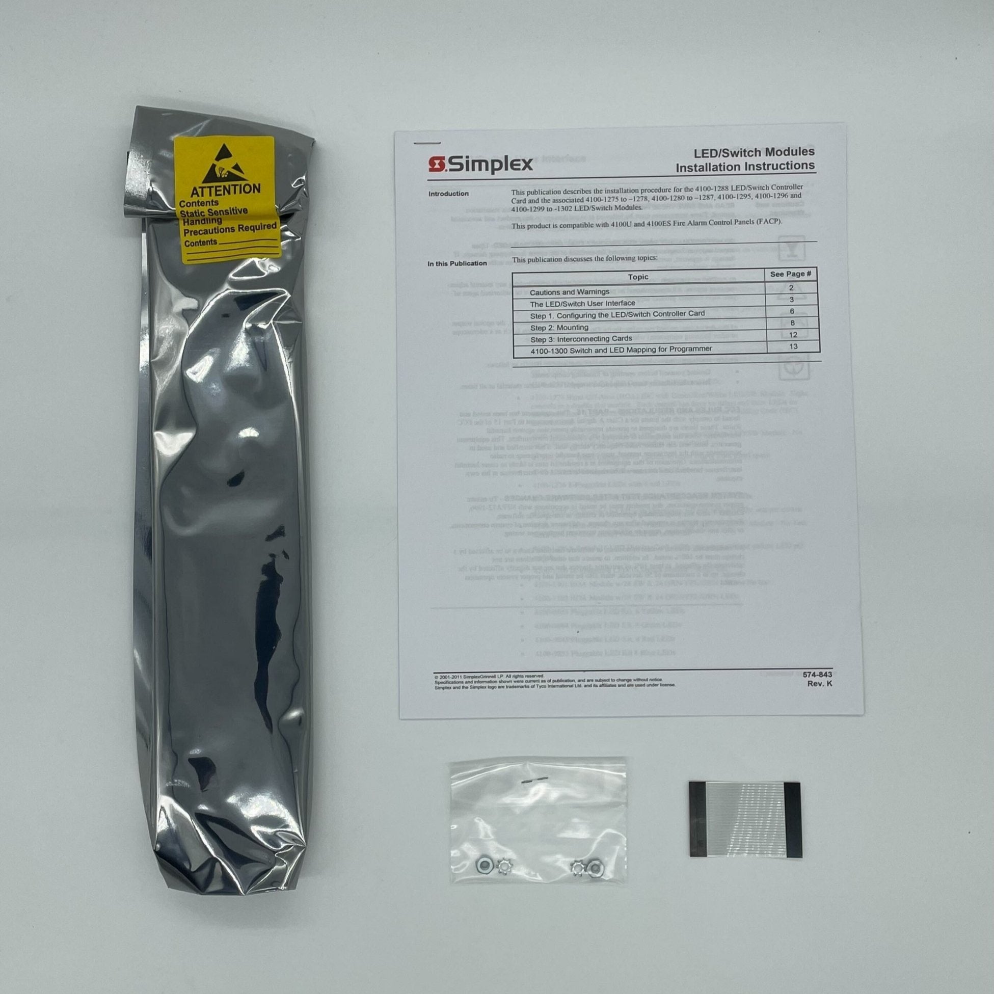 Simplex 4100-1277 fire alarm system with control panel, mounted on wall, in a commercial setting.