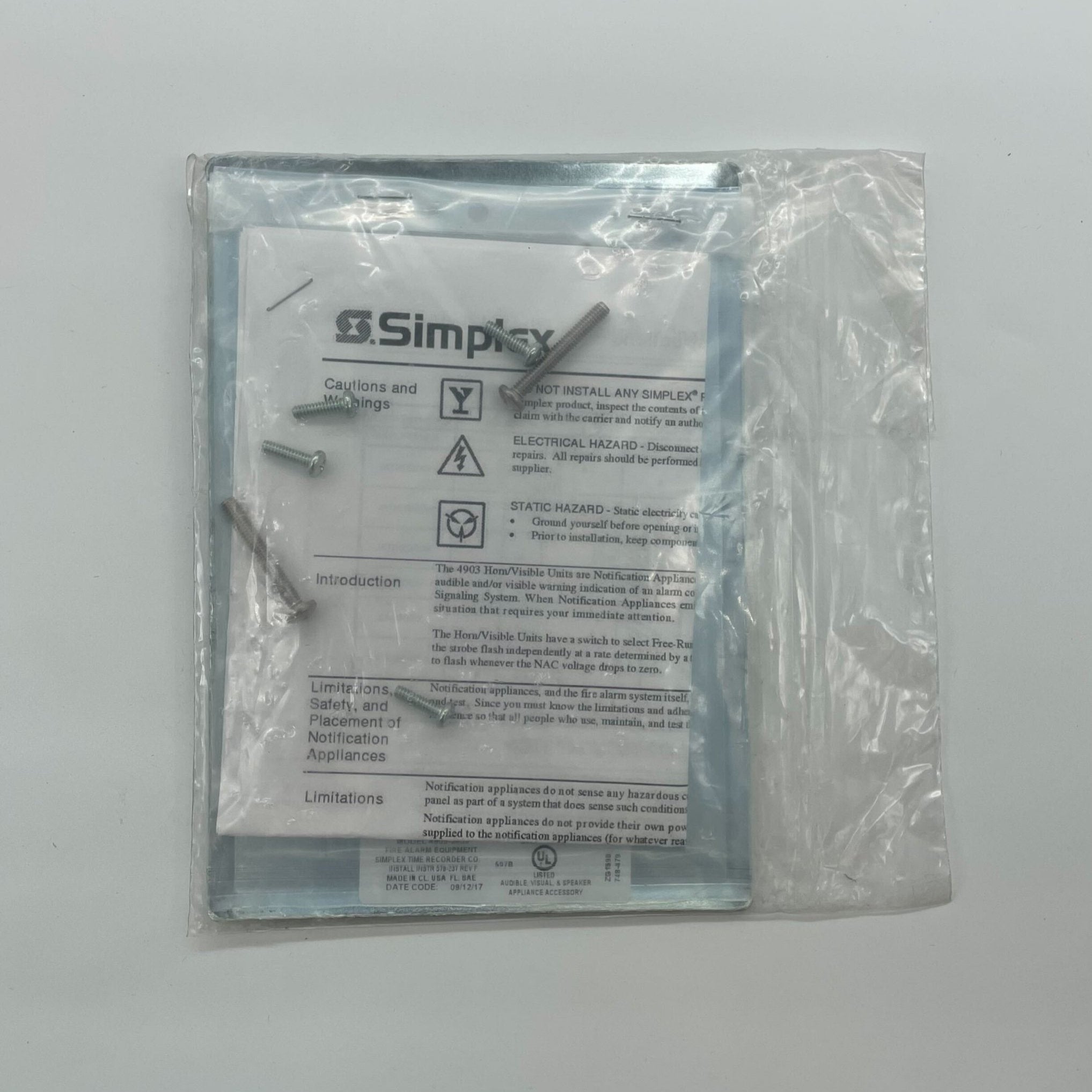 Simplex 4905-9939 fire alarm with white plastic casing and mounting bracket, designed for building fire safety systems.