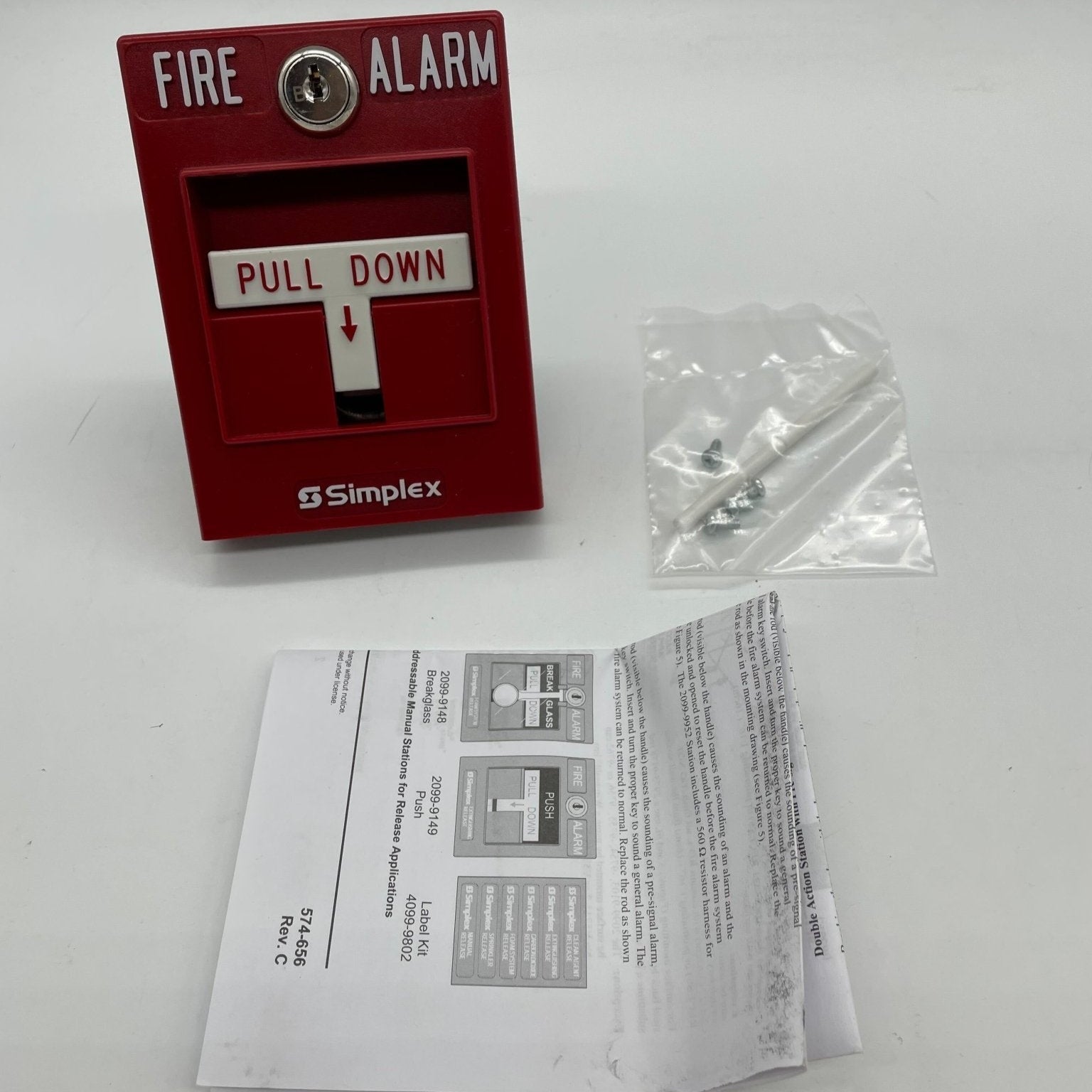 Simplex 2099-9754 single action manual pull station for fire alarm systems, mounted on wall with clear label.