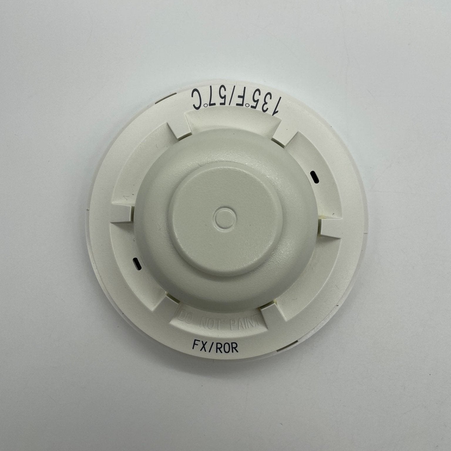 System Sensor 5621 smoke detector mounted on ceiling, featuring a white alarm unit with electronic sensors for fire detection.